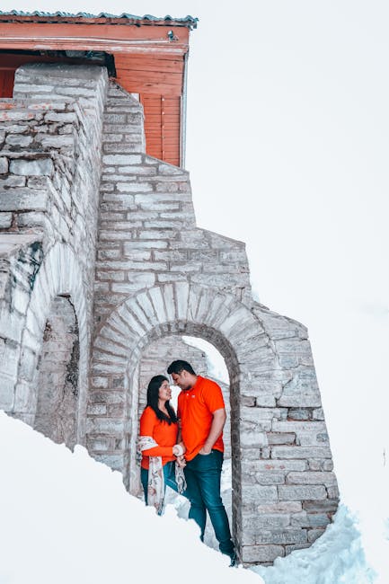 Supportive partnership standing under a stone arch